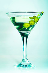 Martini glass with green olives