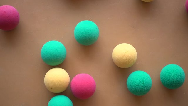 Colorful sponge ball on brown background