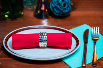 table with tableware at the bar is beautifully set with red candles and for a night celebration party.