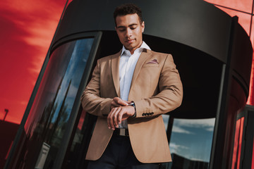 Young trendy man is rushing to business meeting