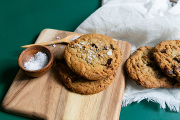 Homemade Salted Chocolate Chip Cookies on Colorful Green Background, Styled Flat Lay Dessert 