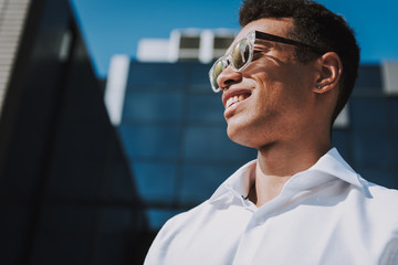 Happy businessman is relaxing outdoor after working day