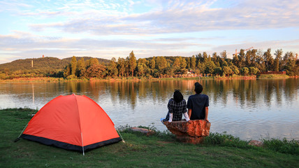 People seat with tent near East Lake of Hubei province. East Lake Scenic Area of Wuhan