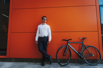 Cheerful business man is choosing bicycle for commuting