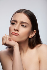 Fototapeta premium Sad lady posing against light gray background in studio