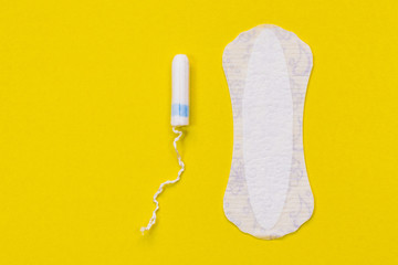 Hygienic white tampon for women. Cotton swab. Menstruation, means of protection. Tampons on a yellow background.