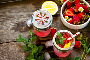 Fresh Strawberry lemonade on rustic wooden table.
