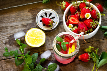 Fresh Strawberry lemonade on rustic wooden table.