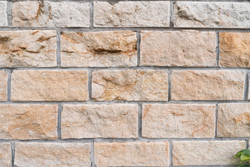 Light stone tiles wall as a background.