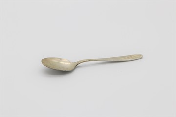 Vintage silverware, antique tea spoon on white background with copy space