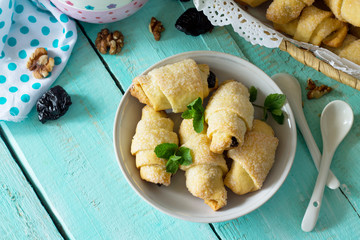 Homemade cookies with dried prunes and walnuts on a rustic wooden table. Free space for your text.