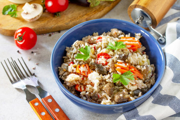 Diet menu. Healthy food. Vegetarian vegetable mushrooms pilaf. Rice with eggplant and mushrooms on stone table.