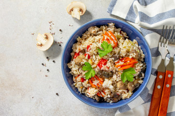 Diet menu. Healthy food. Vegetarian vegetable mushrooms pilaf. Rice with eggplant and mushrooms on stone table. Top view flat lay. Free space for your text.