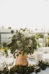 Flowers in a vase on the table as a decoration. Event or celebration.