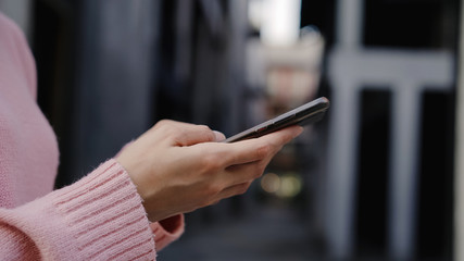 Cheerful Asian backpacker blogger woman using smartphone for direction and looking on location map while traveling at Chinatown in Beijing, China. Lifestyle backpack tourist travel holiday concept.