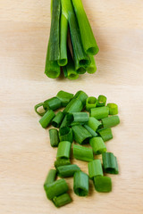 Sliced green onion on a cutting board. Top view.