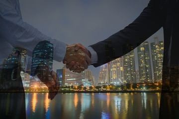double exposure business.Mixed media of handshake.Business people joining hands for success...