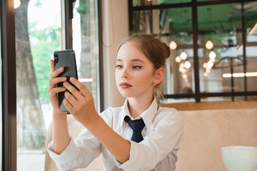 Fototapeta premium Portrait of business girl talking on the phone