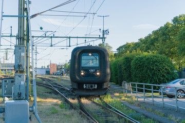 Man driving a train towards the railway station