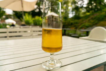 Half full draft beer standing on a white table