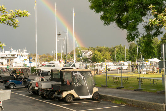 Rainbow strikes on a white house on a cloudy day