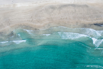 Aerial vertical View Splashing Sea Waves on the Beach