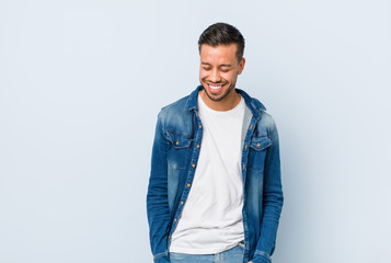 Fototapeta premium Young handsome filipino man joyful laughing a lot. Happiness concept.