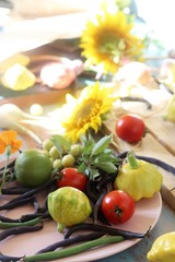 Bright fresh vegetables, fruits and flowers on a wooden table, healthy food, the season of summer, autumn