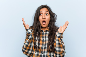 Young cool indian woman surprised and shocked.