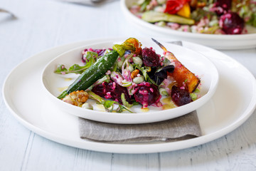 Bulgur wheat salad with roast beetroots, carrots, zucchini and green peas