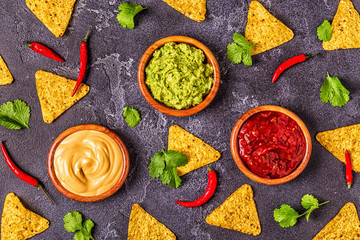 Mexican food background: guacamole, salsa, cheesy sauces