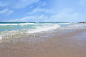 Sunny Bulgarian beach tranquil landscape. Empty coastline on the shore of the Black Sea, Shabla. Perfect place for relaxation on the summer sunny weekends. Clean water and blue sky seascape.