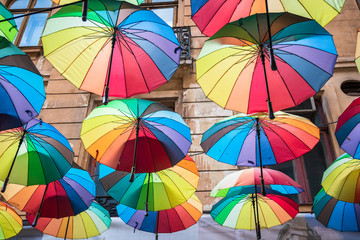 Many colorful umbrellas above the street