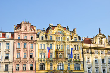 Fototapeta na wymiar Traditional historical houses with colorful facades on the Old Town Square in beautiful Prague, Czech Republic. Shot in morning golden hour. City center, landmarks. Tourist place.