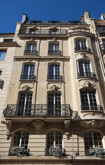 Fototapeta na wymiar Traditional French house with typical balconies and windows. Paris.