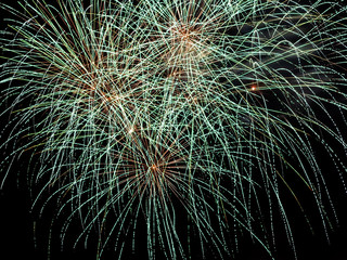 Beautiful fireworks close-up making colorful light paths and patterns in the dark sky