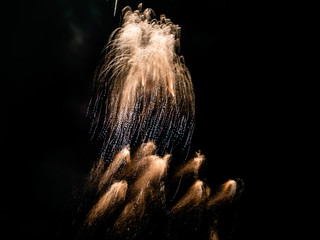 Beautiful fireworks close-up making colorful light paths and patterns in the dark sky