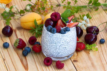 Chia seed pudding with berries on wooden table. rustic stile healthy Breakfast. Chia seed with...