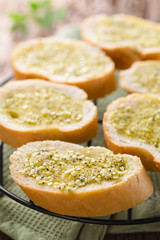 Fresh homemade garlic bread, slices of baguette seasoned with garlic, oregano, salt, pepper and olive oil (Selective Focus, Focus in the middle of the first bread)