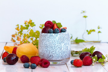 Chia seed pudding with berries on wooden table. rustic stile healthy Breakfast. Chia seed with milk, fruits and fresh berry. well being weight loss concept. yogurt drink, vitamin cocktail.
