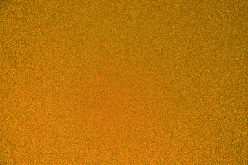 An abstract orange background made of twinkling glitter that is great for a background for Christmas and other celebrations.