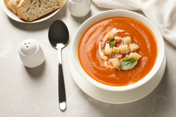 Bowl of tasty sweet potato soup served on table, above view