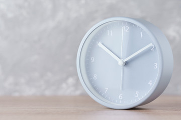Classic alarm clock on a gray background with copy space