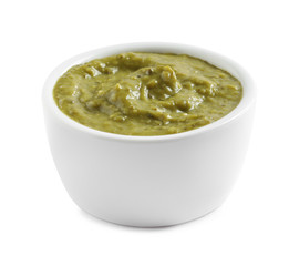 Delicious pesto sauce in bowl on white background