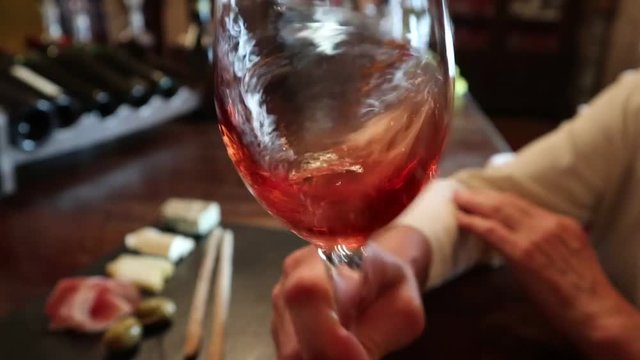 Wine test, crystal glass, red wine, cheese, bar counter background. Glasses of wine and cheese plate. Wine testing.