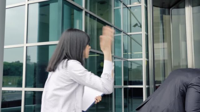 Business man leaving the office touching colleague woman for booty. She slapping him by the face. Sexual harassment