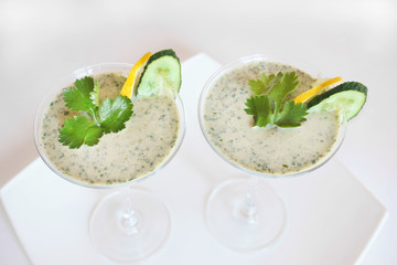 Smoothies green on the table in two glasses