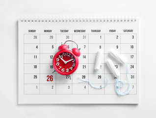 Calendar, tampons and clock on white background, top view. Gynecology concept