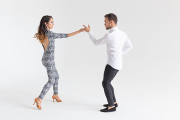 Social dance, kizomba, tango, salsa, people concept - beautiful couple dancing bachata on white background with copy space