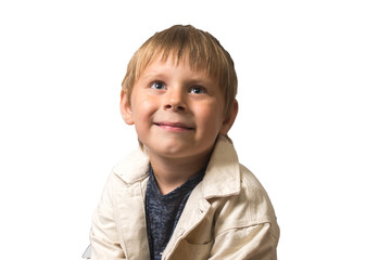 Attractive little boy 5-7 years old in a white jacket is smiling on a white background. Isolated